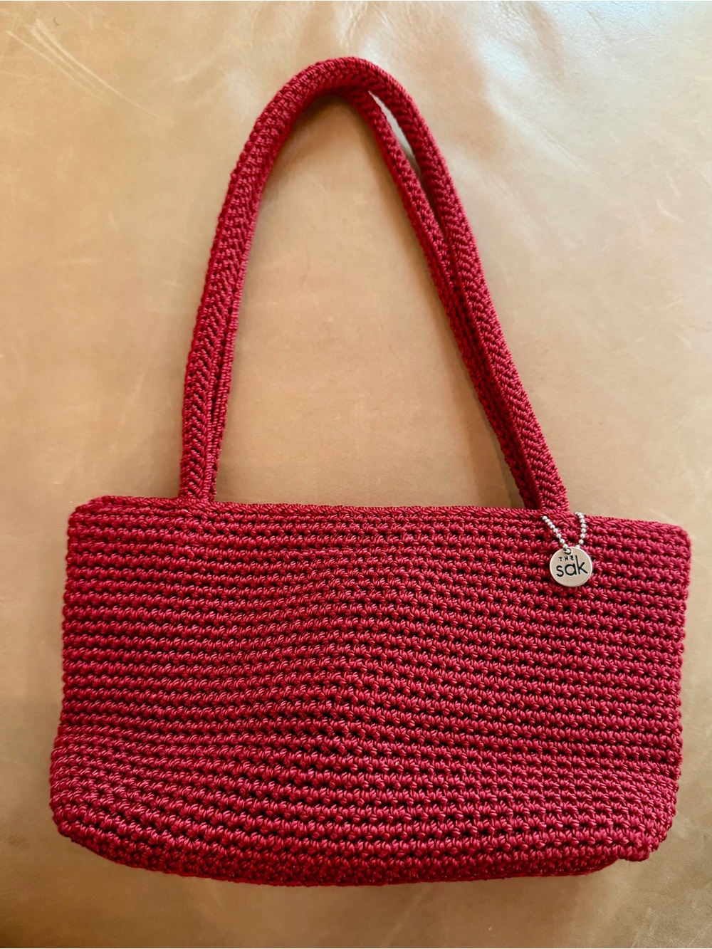 The Sak Red Crochet Shoulder Bag with Logo Charm